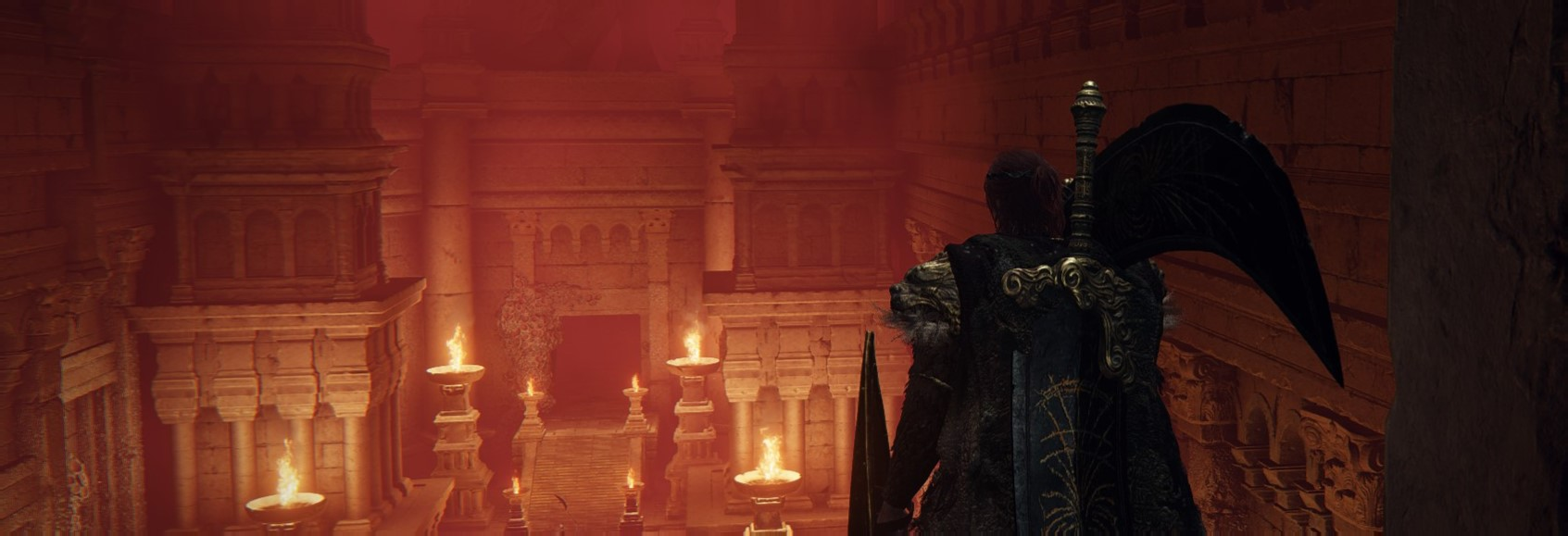 The player peers through red fog upon an ancient stone city.